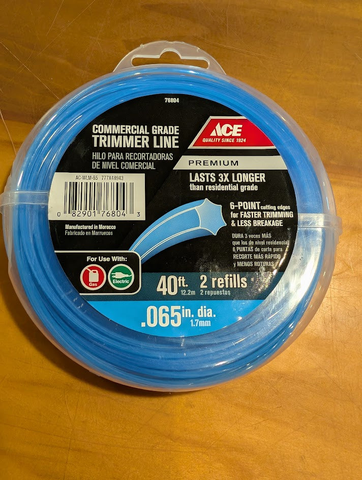 Ace brand commercial grade trimmer line packaging on a wooden surface