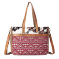 Handbag with red geometric pattern and cowhide leather accents on a white background