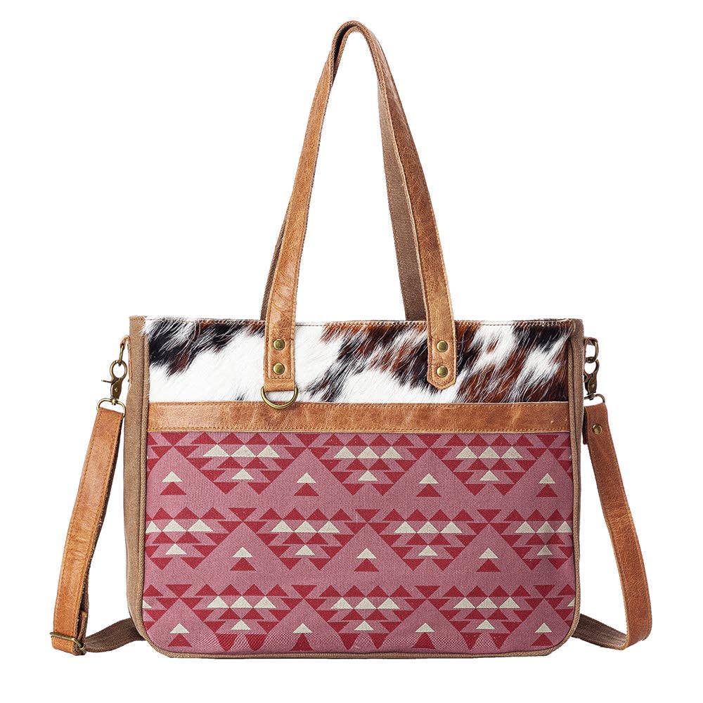 Handbag with red geometric pattern and cowhide leather accents on a white background