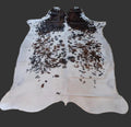 Cowhide rug with a gray background.