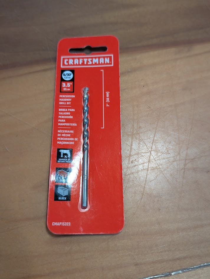 Drill bit in Craftsman packaging on a wooden surface