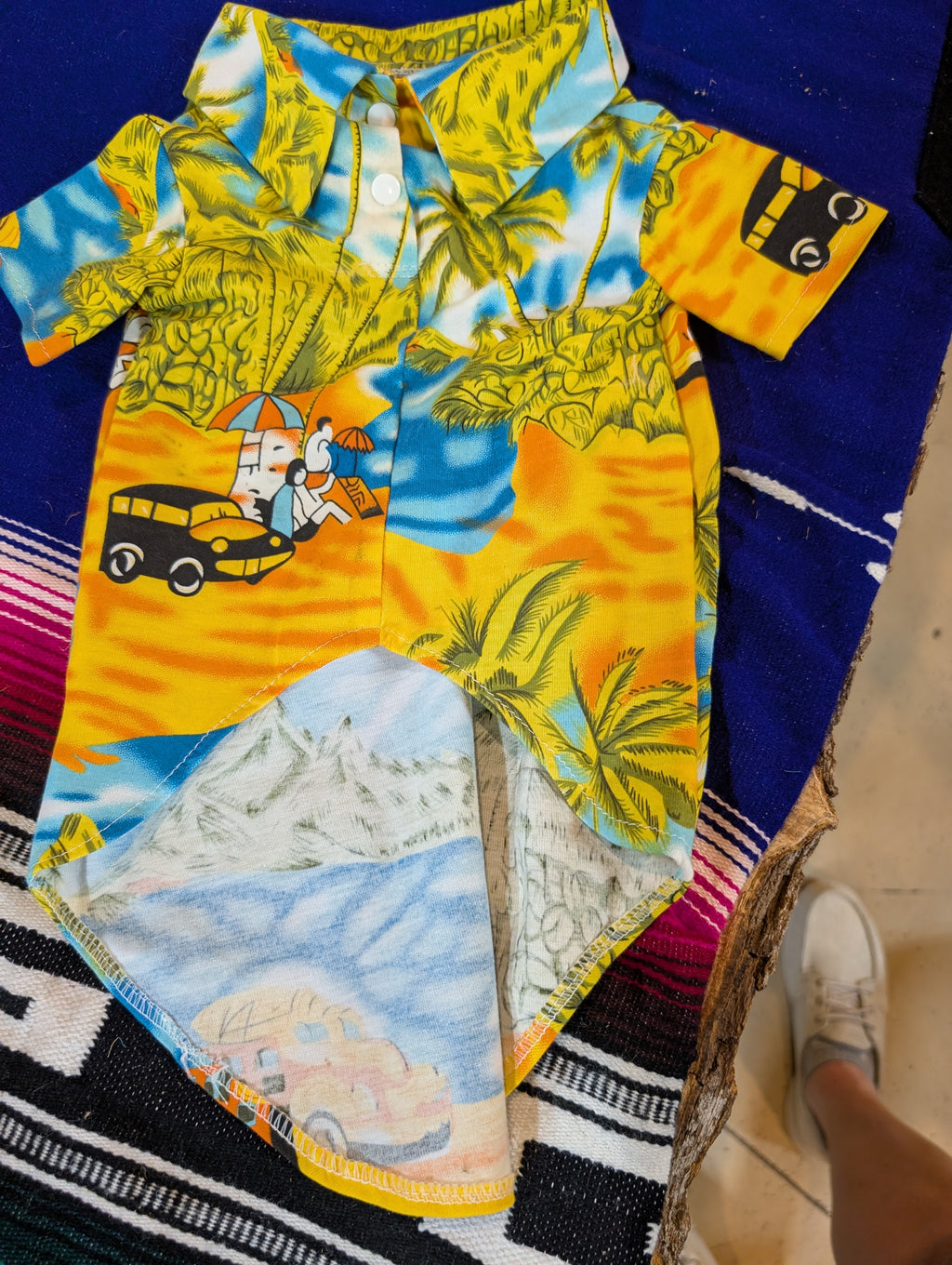 Bright tropical summer dog shirt laid flat on wooden deck