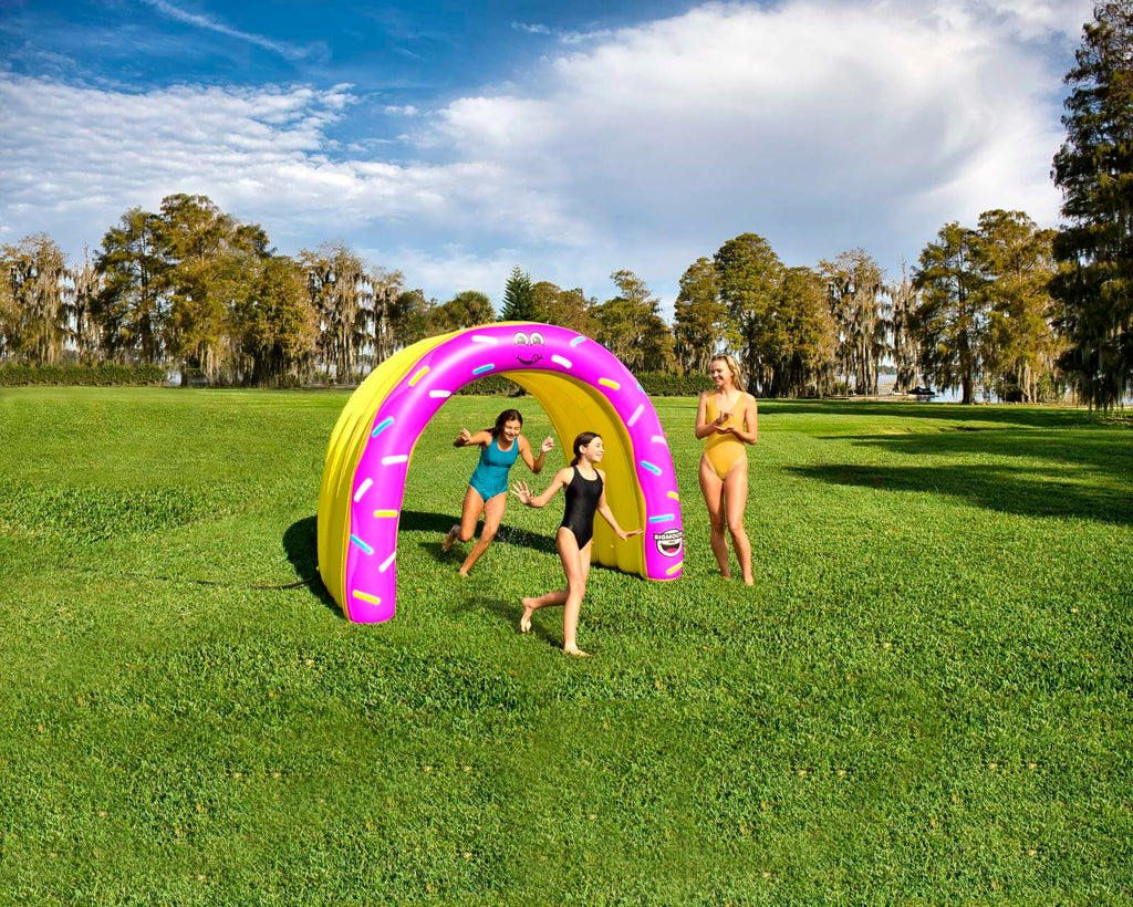 Three people playing with a large inflatable