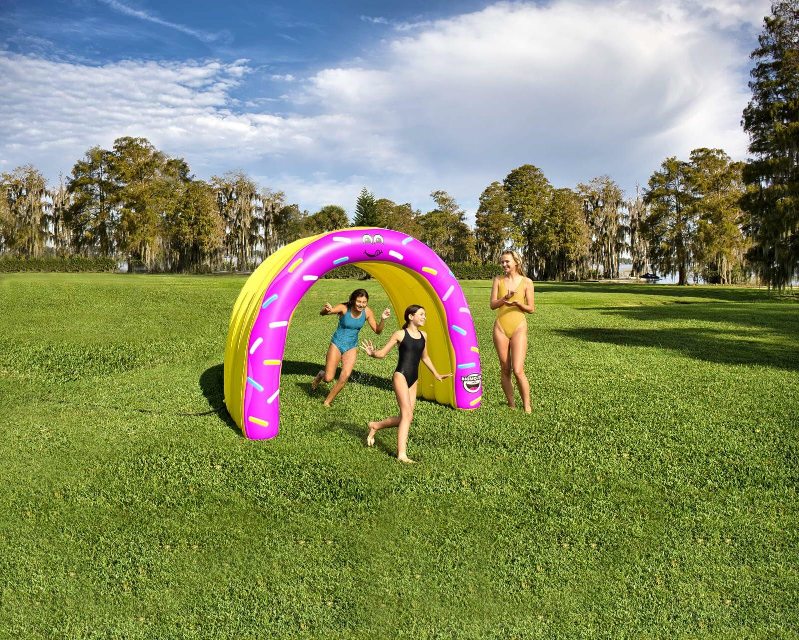 Three people playing with a large inflatable