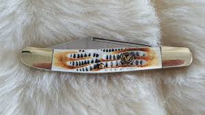 White bone pocket knife on a white surface