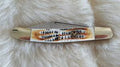 White bone pocket knife on a white surface