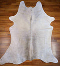 Grey and white  Full Cowhide rug on wood floor