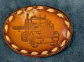 Brown leather belt buckle with truck design on a blue textured background