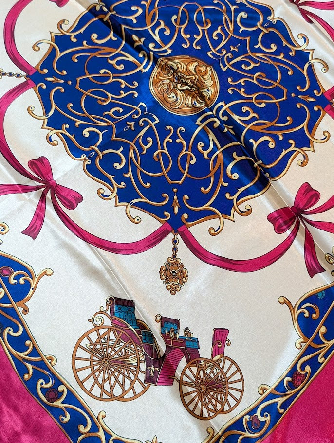 close up of a Fuchsia color scarf/wild rag with bows & wagon