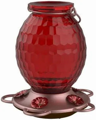 Red glass hummingbird feeder with textured
