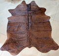 Brown cowhide rug on a light tiled floor