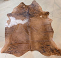 Brown cowhide rug on a tiled floor