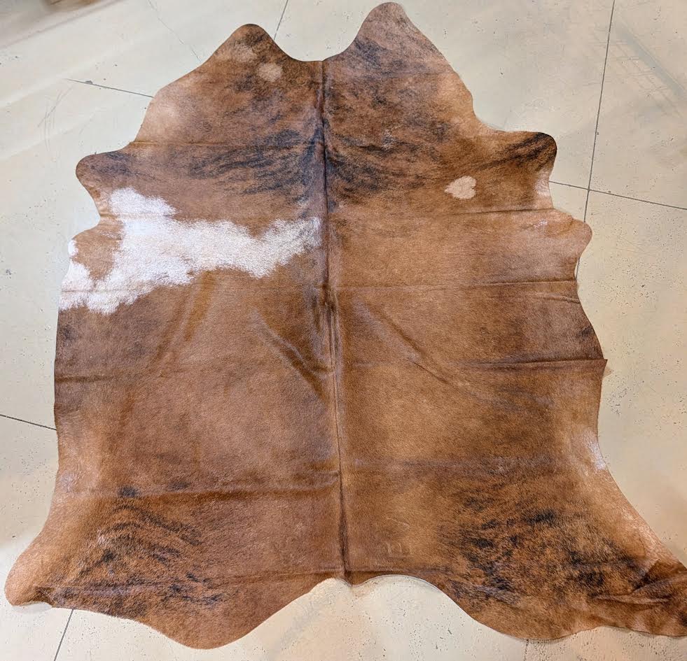 Brown cowhide rug on a tiled floor