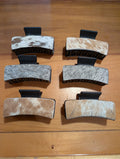 Set of six hair clips with Genuine Cowhide Claw Hair Clip on a wooden surface