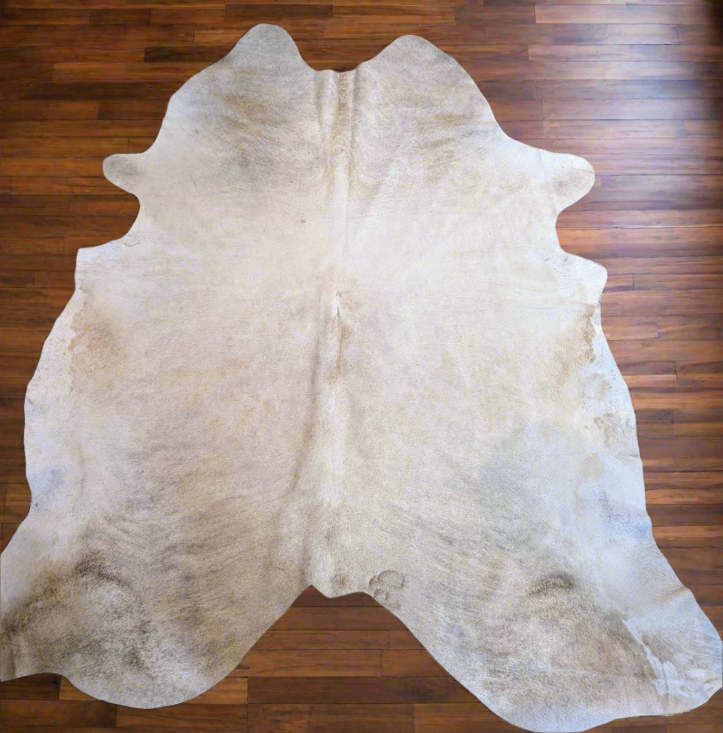 Authentic blonde branded cowhide with golden tones and rustic character