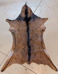 Brown and Black Goat hide on a tile floor 