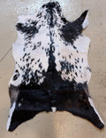 Spotted goat hide on a beige floor