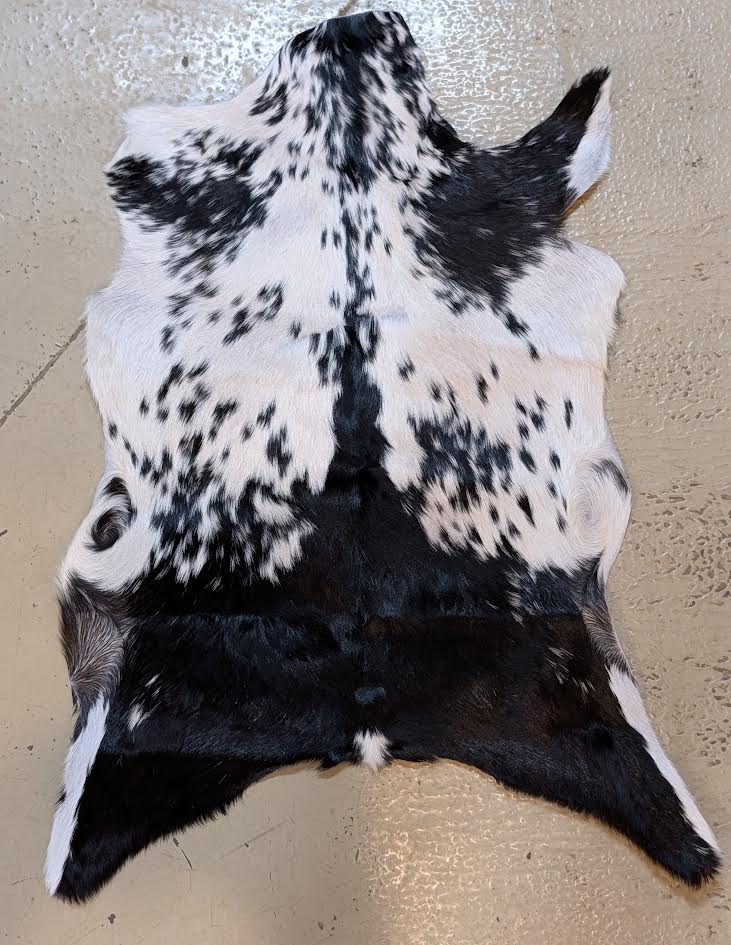 Spotted goat hide on a beige floor
