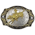 A belt buckle with a design of a golden bull rider on a silver background with black ornamental frame.