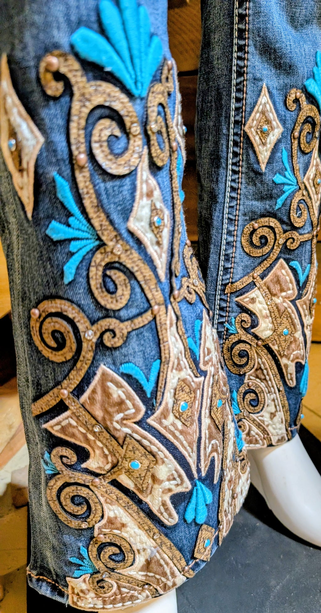 The jean is detailed with an Aztec embroidery design on the leg, embroidered back pockets, added embellishment on the front pockets, natural hand-sanding, and whiskering. 