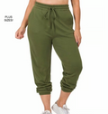 Green jogger pants worn by a person on a white background