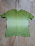 Green Zenana Dip Dye short sleeve top on a beige rug.