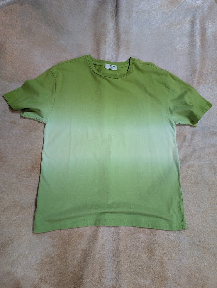 Green Zenana Dip Dye short sleeve top on a beige rug.