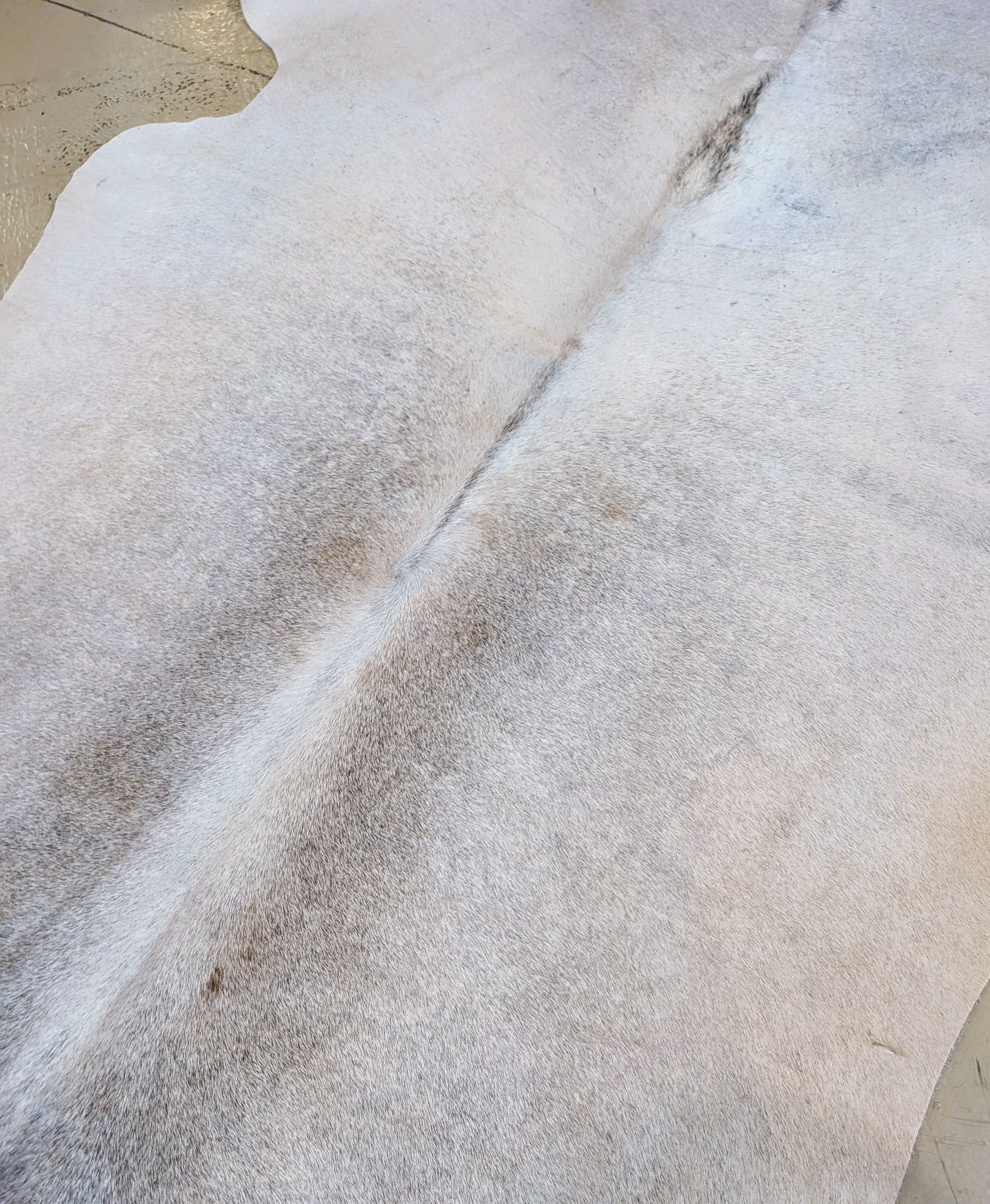 Cowhide rug on floor