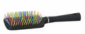 Black hairbrush with colorful bristles on a white background