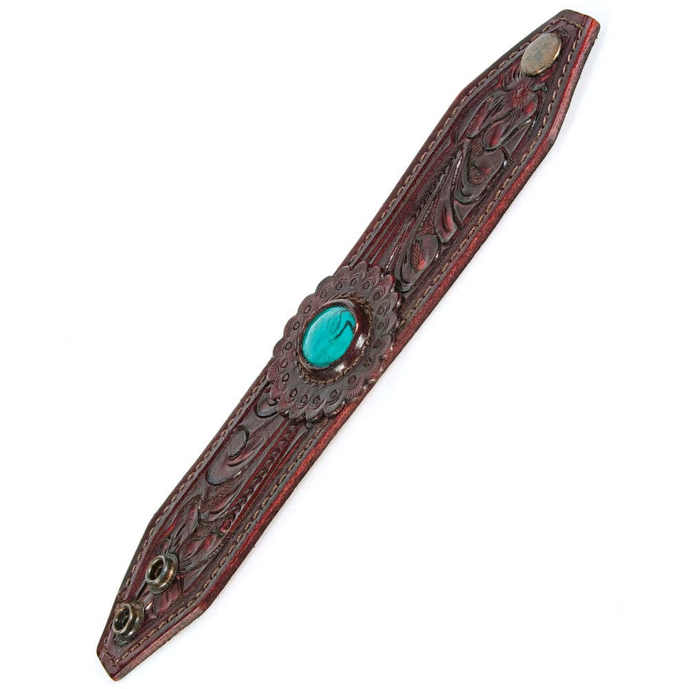 Decorative cuff bracelet with turquoise stone on a white background