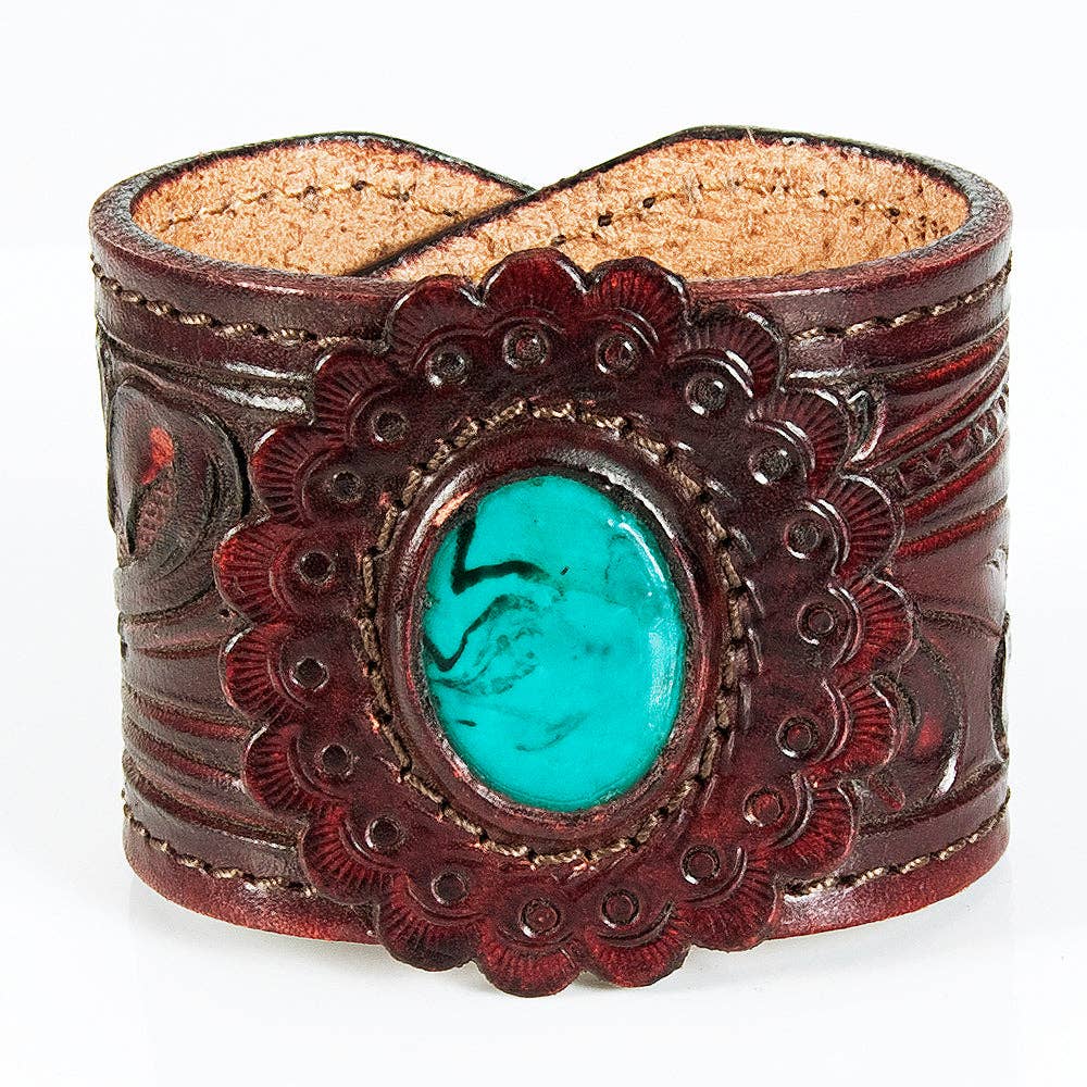 Brown leather cuff bracelet with turquoise stone on a white background