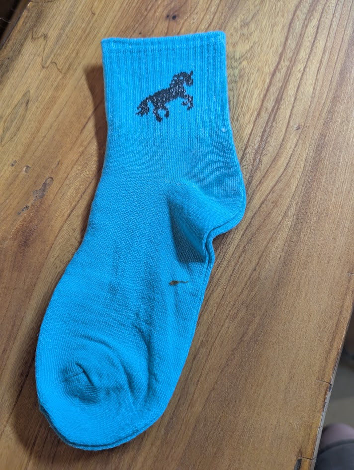 Blue ankle sock with black horse on it
