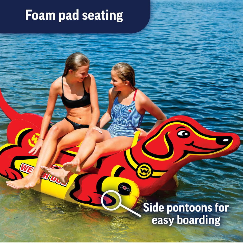 Two people on a red dog-shaped inflatable raft in water 