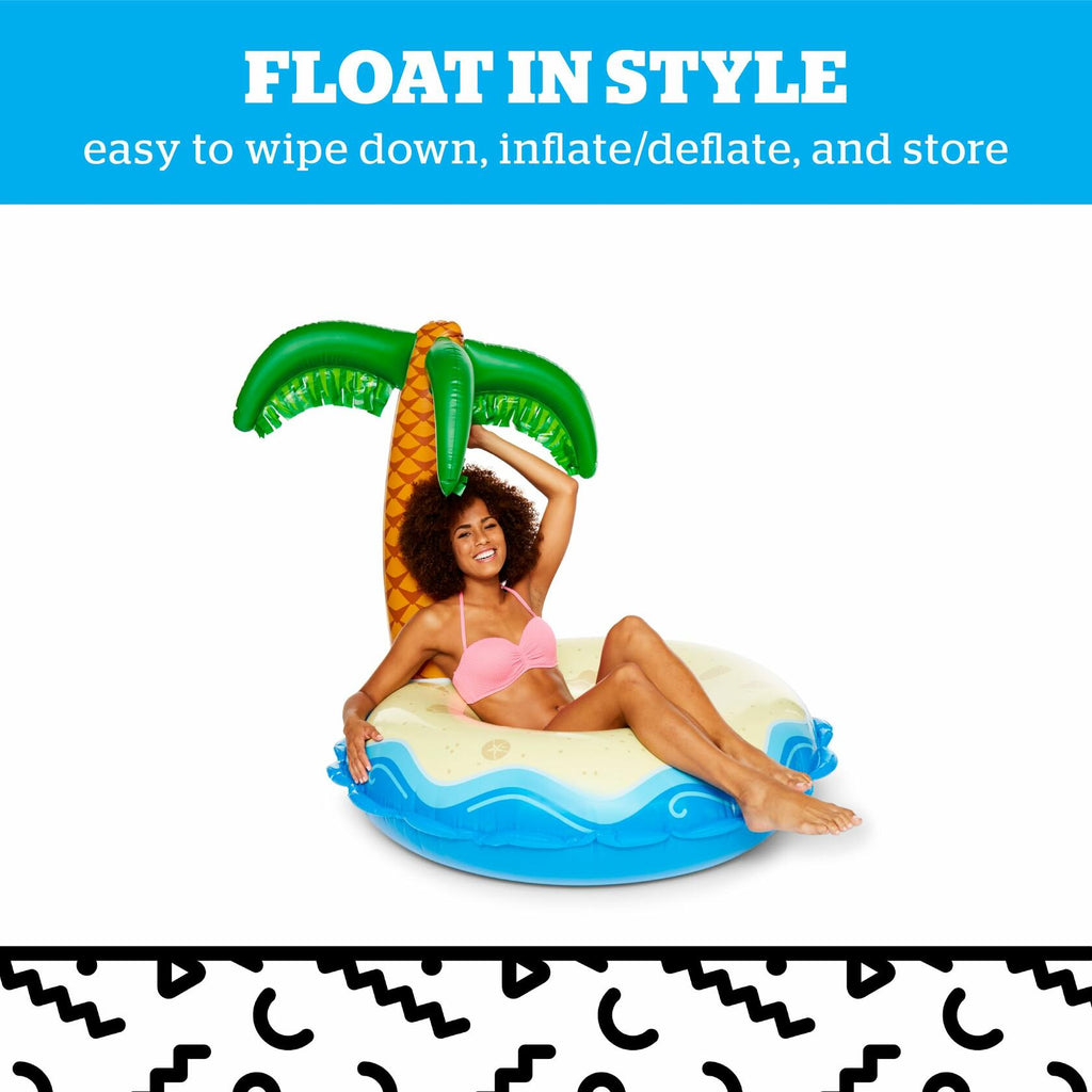 Inflatable pool float with palm tree design held by a woman.