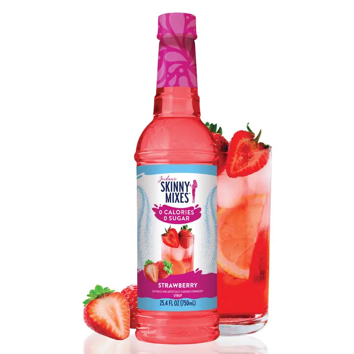 Jordan’s Skinny Mix Sugar Free Strawberry Syrup bottle standing on a kitchen counter with fresh strawberries around it.