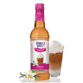 A bottle of Jordan's Skinny Syrups sugar-free vanilla coffee syrup with a glass of coffee and whipped cream on the side.