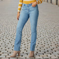LEE Women's Instantly Slims Classic Relaxed Fit Monroe Straight Leg Jean on lady wearing yellow shirt