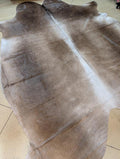 Brown leather hide on a tiled floor