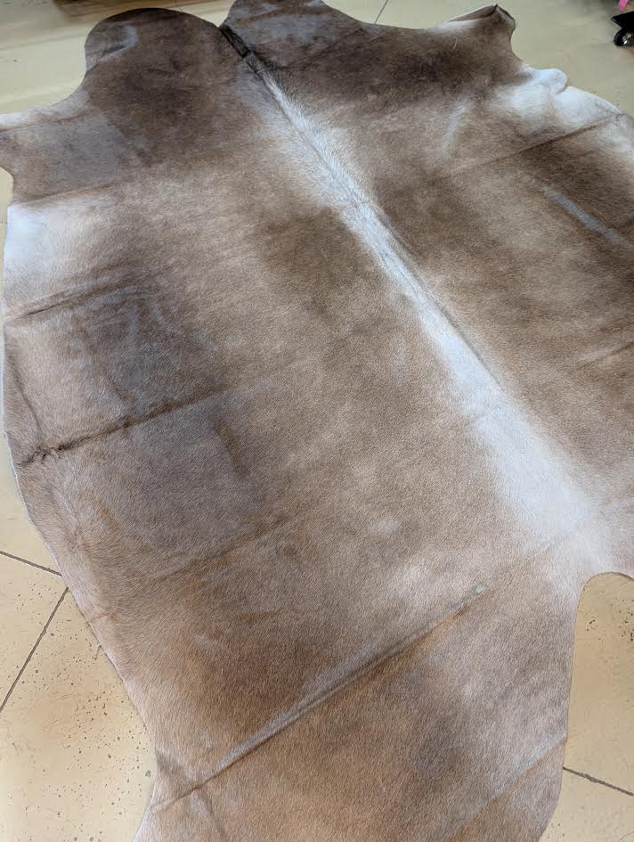 Brown leather hide on a tiled floor