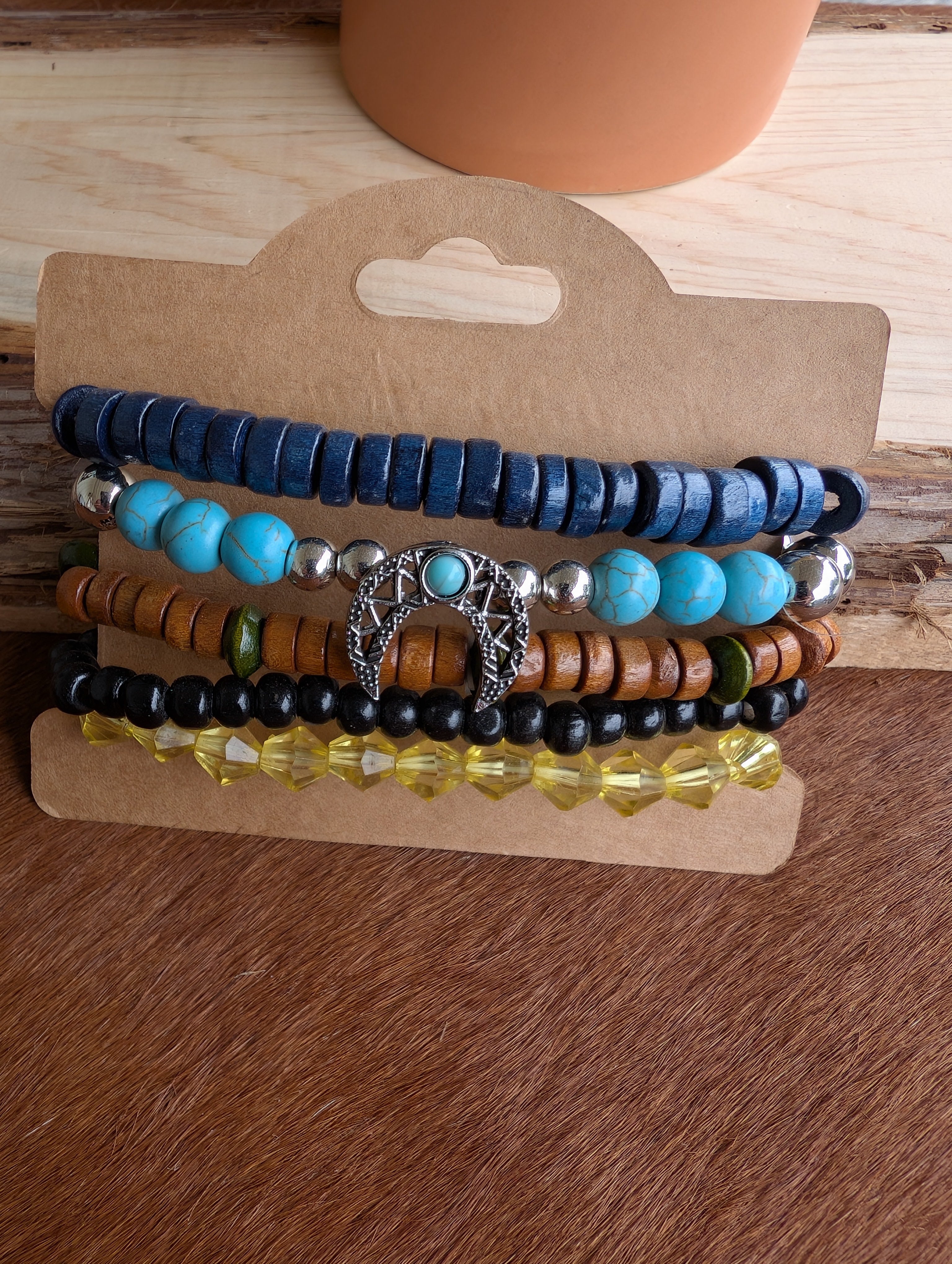 Layered boho bracelet stack in earthy tones on model wrist