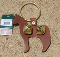 A leather door knocker in the shape of a horse with brass sleigh bells attached to its head.