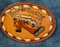  Leather “Keep on Truckin’” Belt Buckle on blue fabric