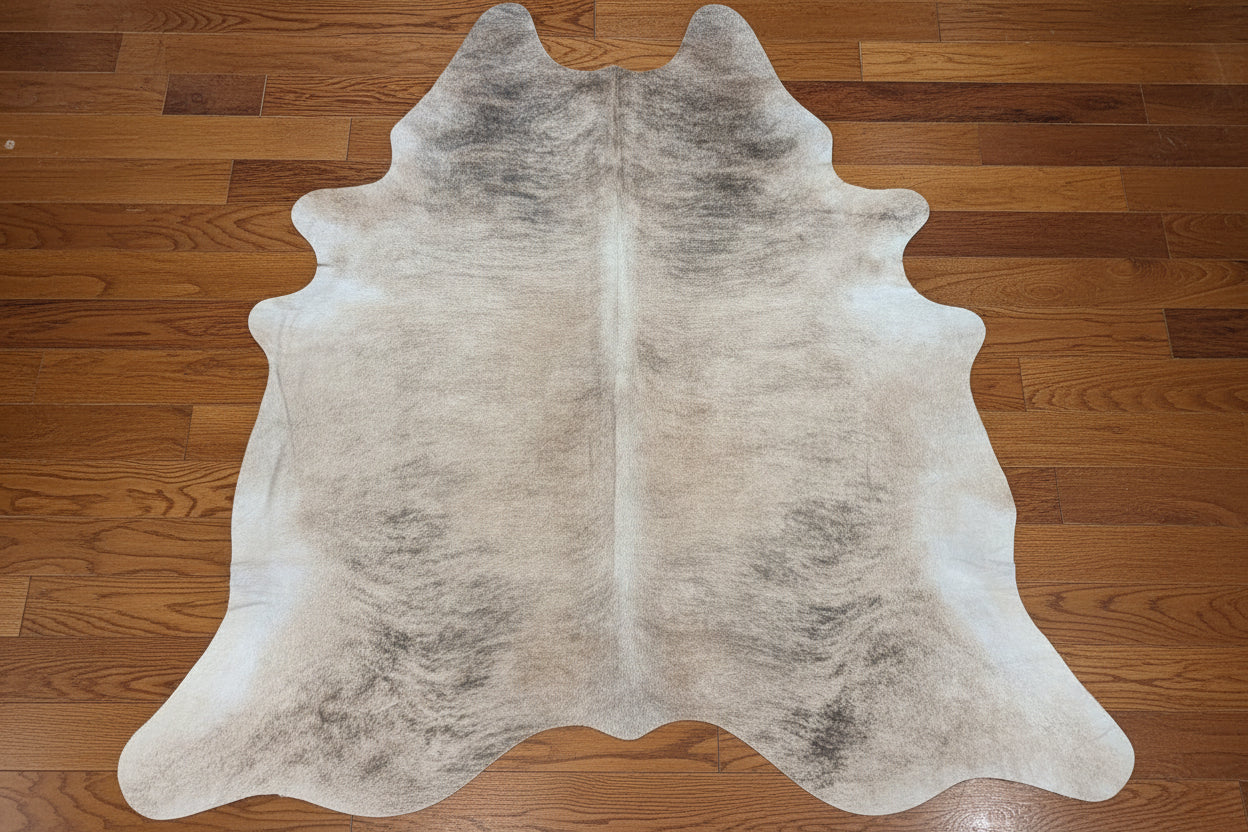 Cowhide rug on a rustic brown wood floor