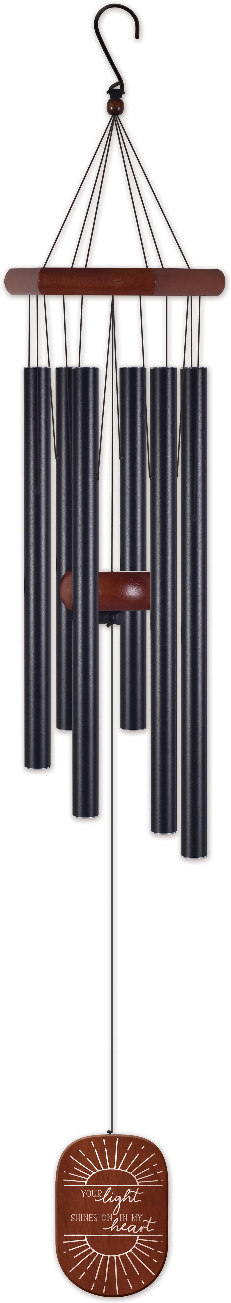 Black wind chime with wooden accents on a white background