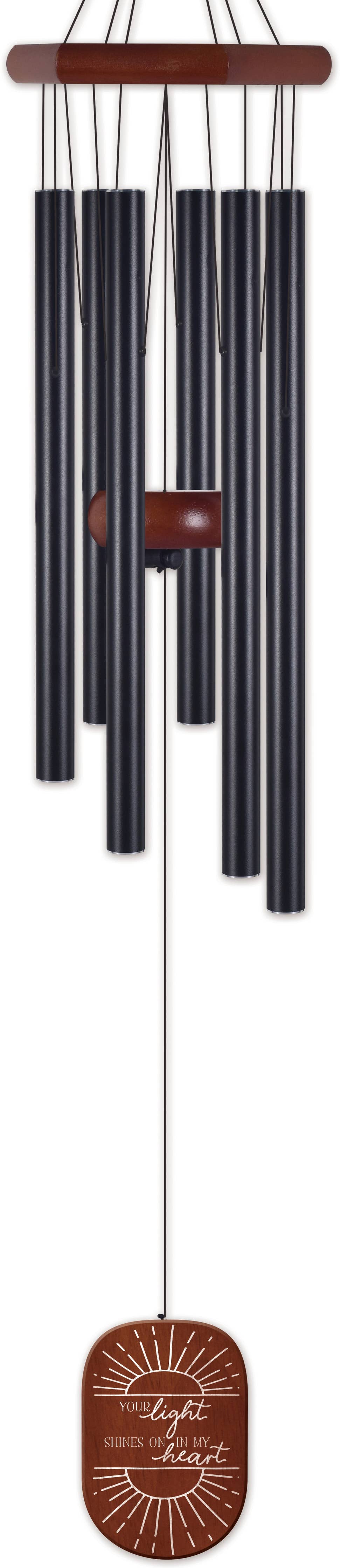 Black wind chime with brown accents on a wooden hanger