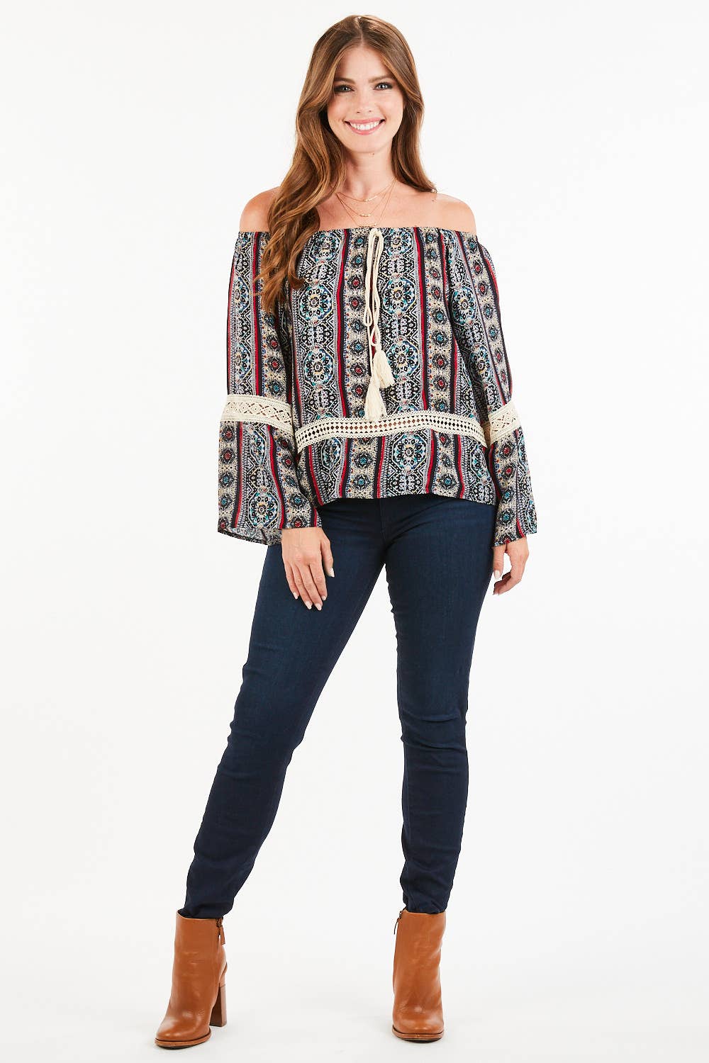 Woman wearing paisley print bohemian top with tassels and off-shoulder neckline