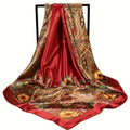 Red silk scarf with intricate gold and brown patterns on a white background