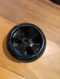 Black wheel on a wooden surface