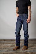 Front view of a man wearing a pair of dark wash kimes ranch zac top jeans.