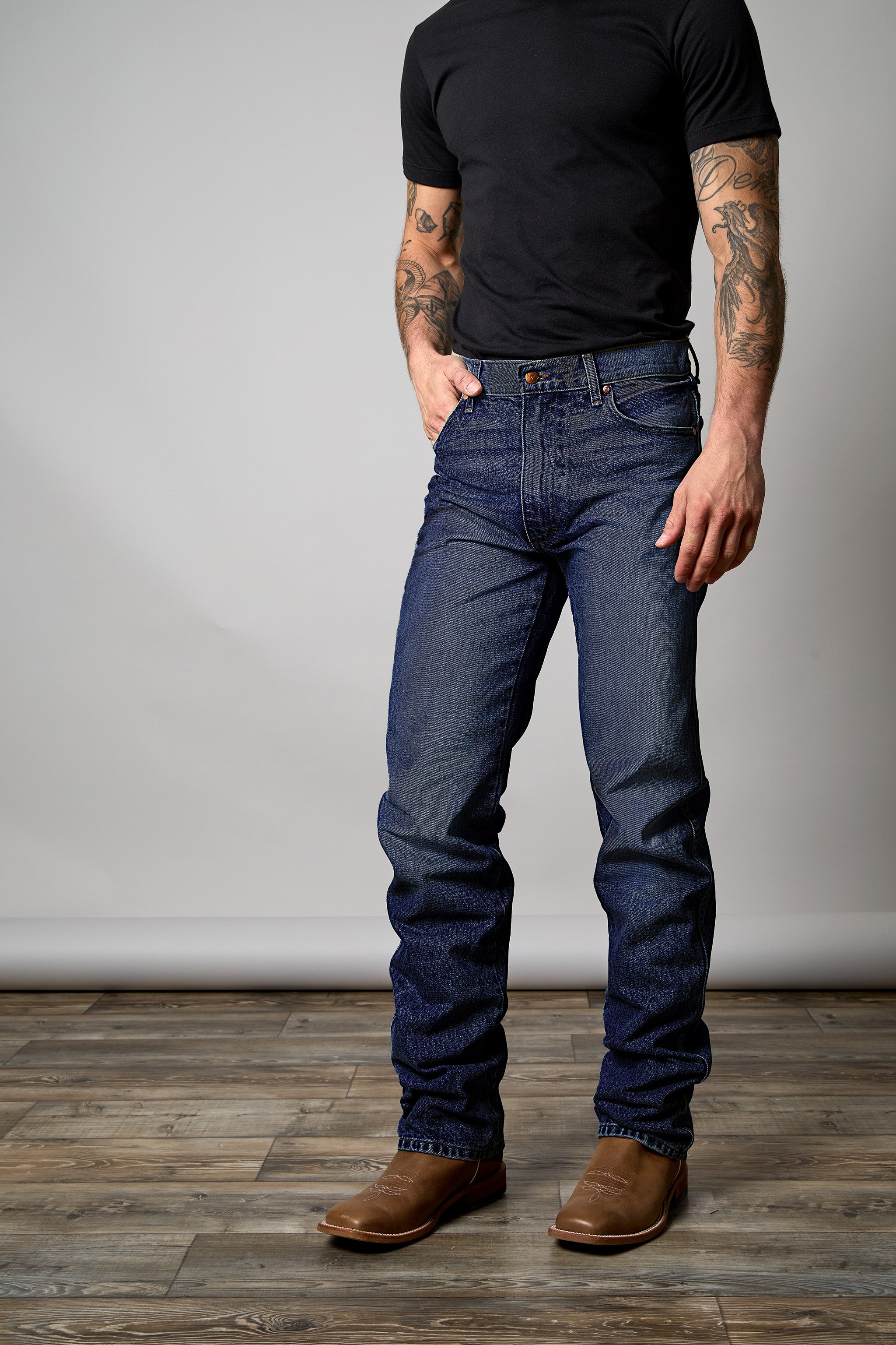 Front view of a man wearing a pair of dark wash kimes ranch zac top jeans.